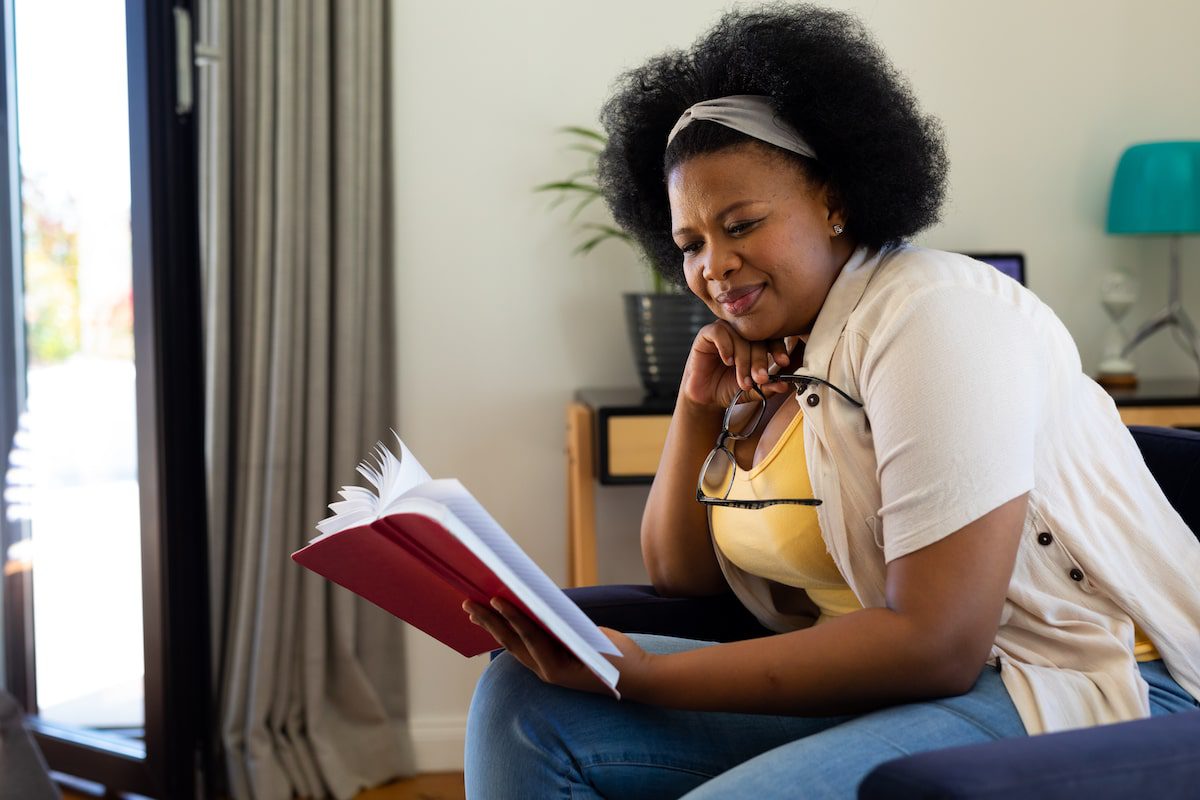 A woman sits and reads a book