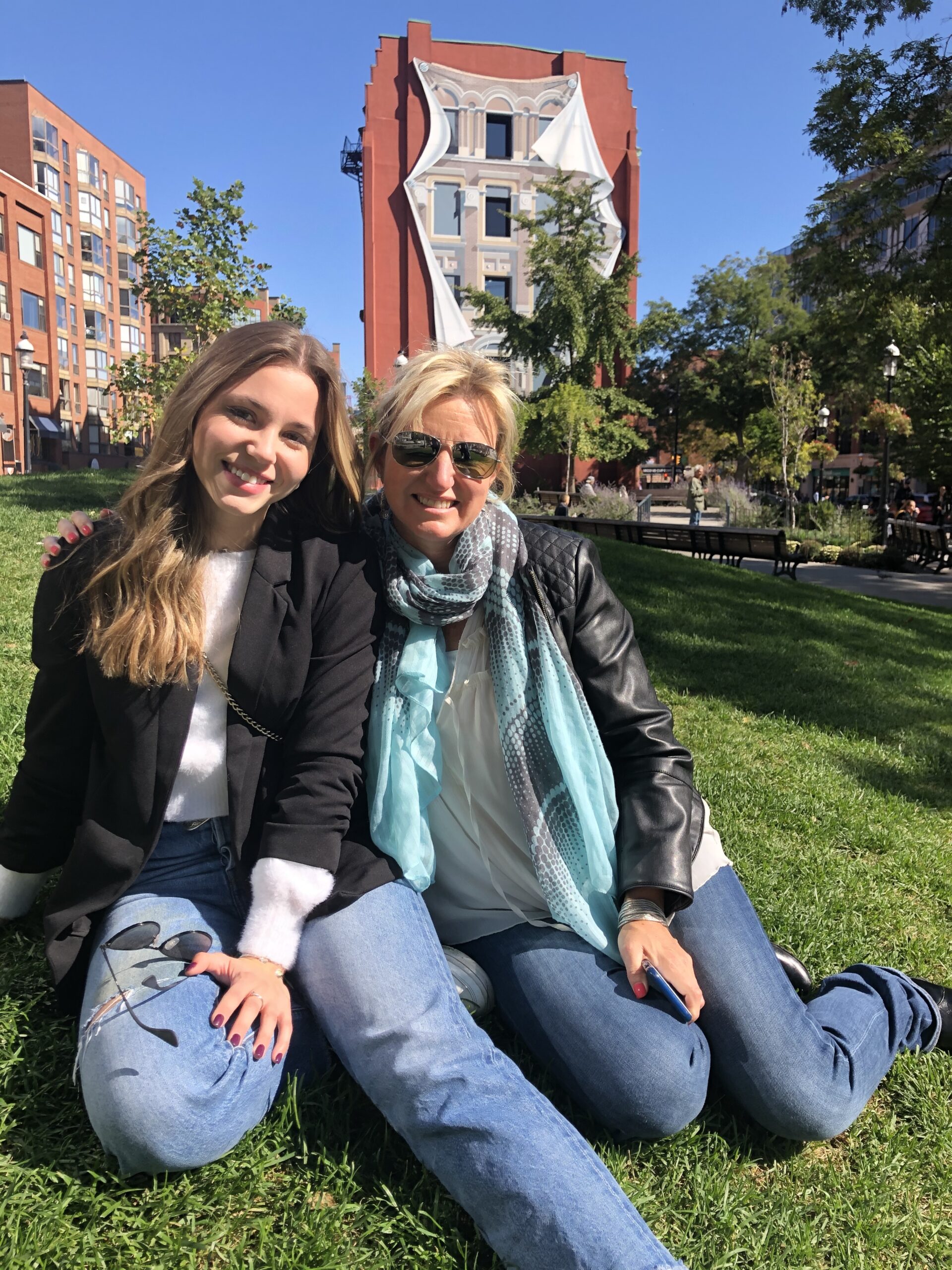 young woman and older woman smiling in the park esplanade Toronto
