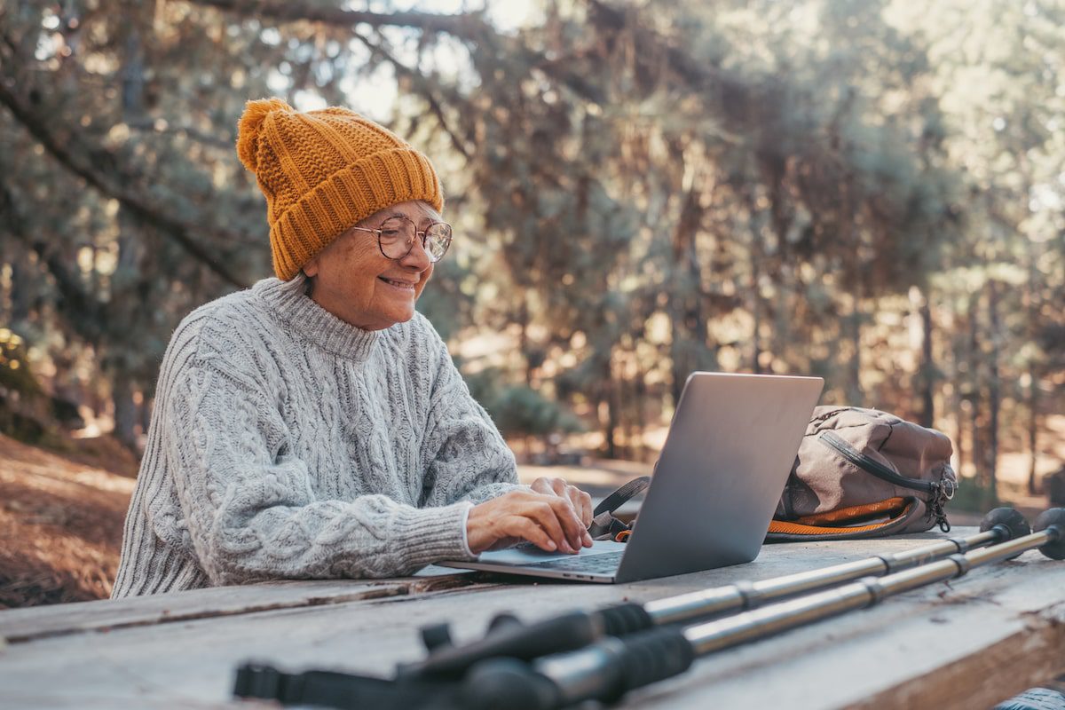 A woman uses a laptop during her travels.