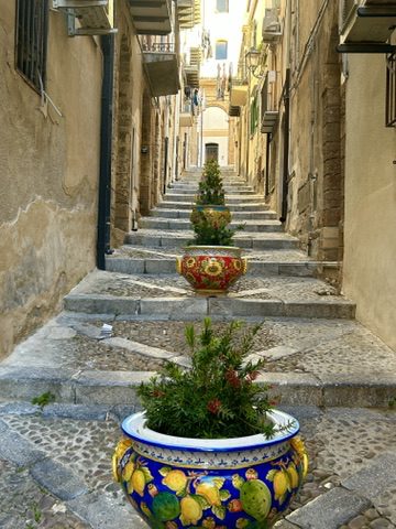 Carolyn Ray in front of the medieval gate in Mdina, Malta