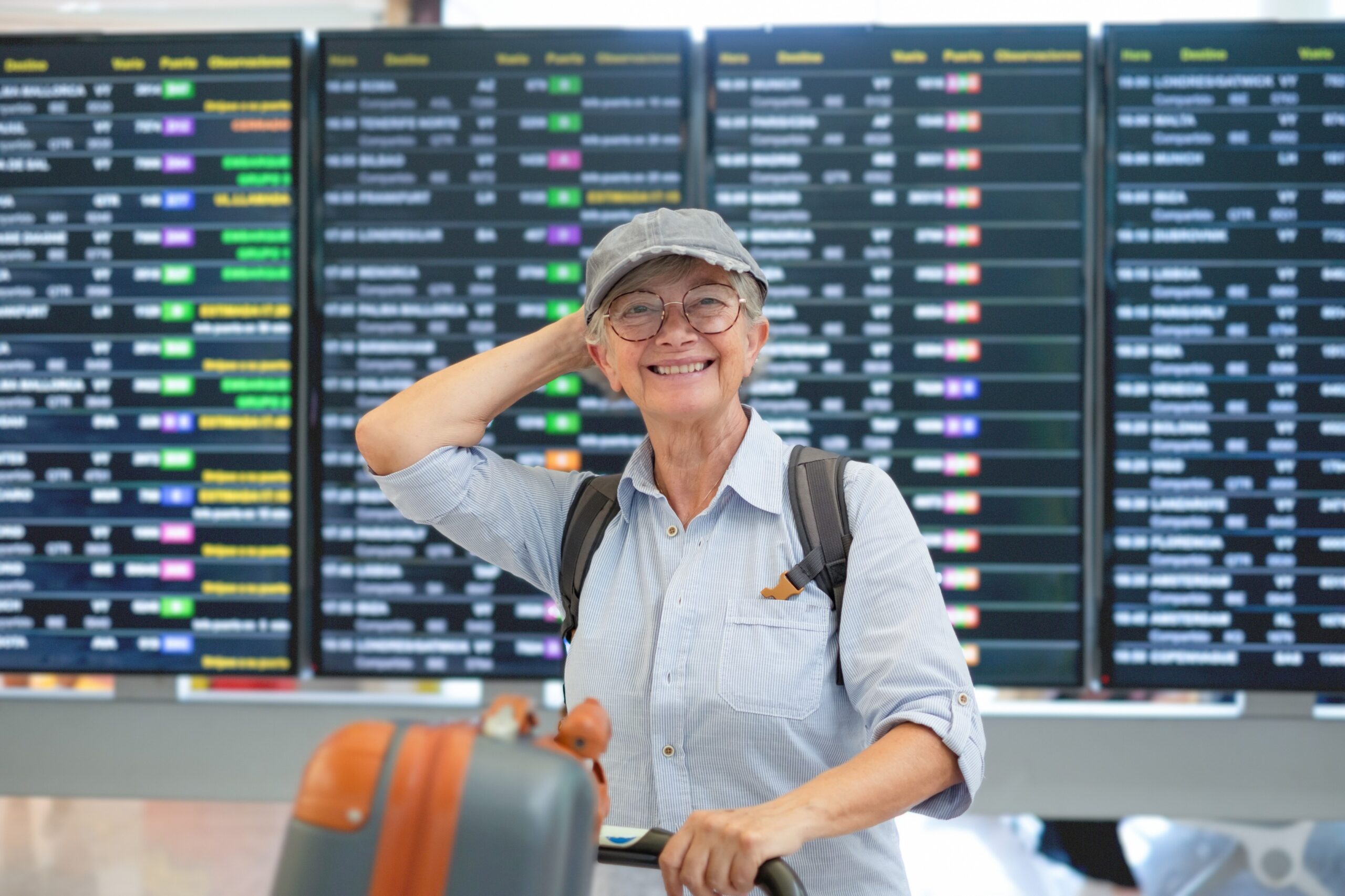 smiling senior woman at airport travelling with medication
