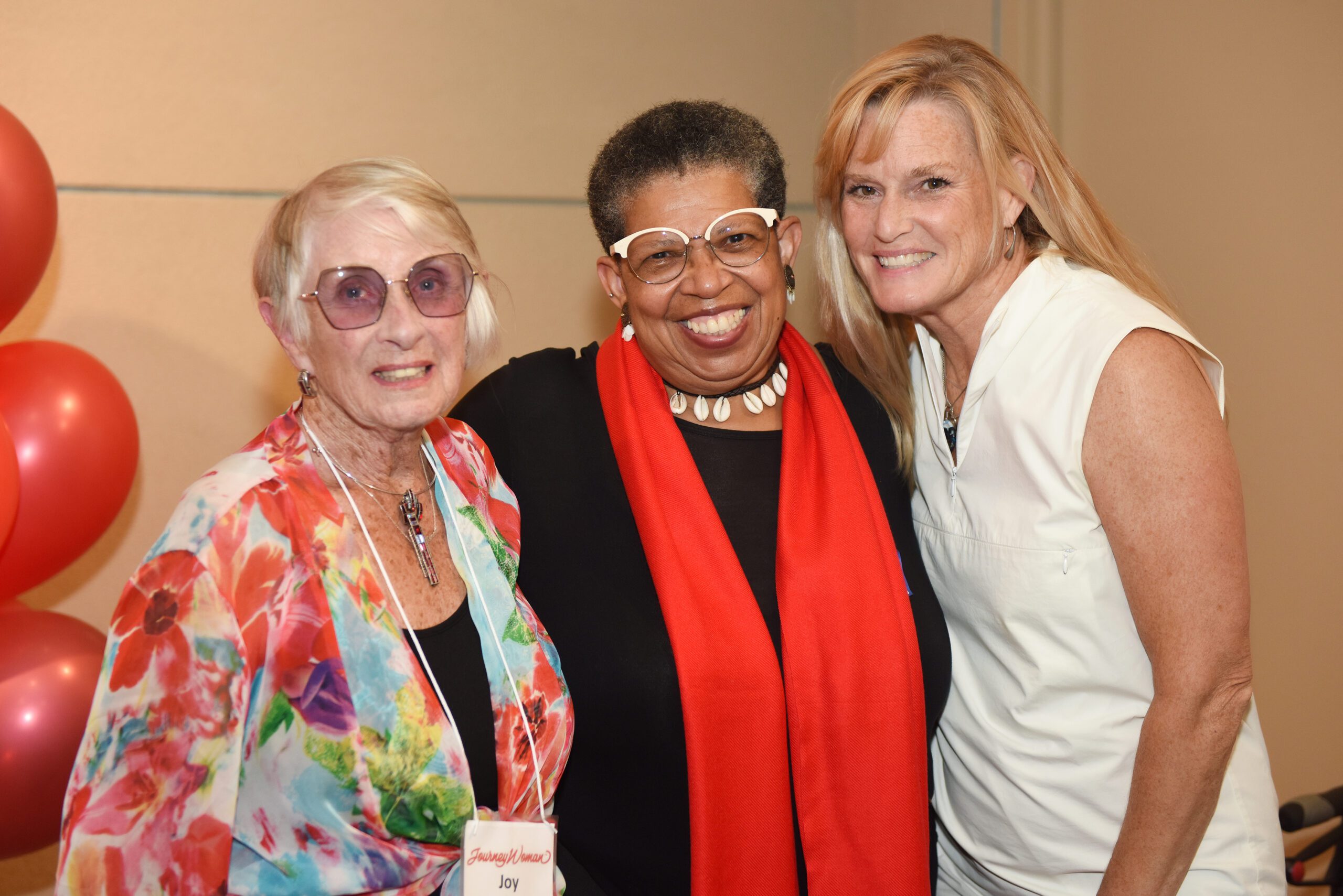 five women standing with 30 balloons 