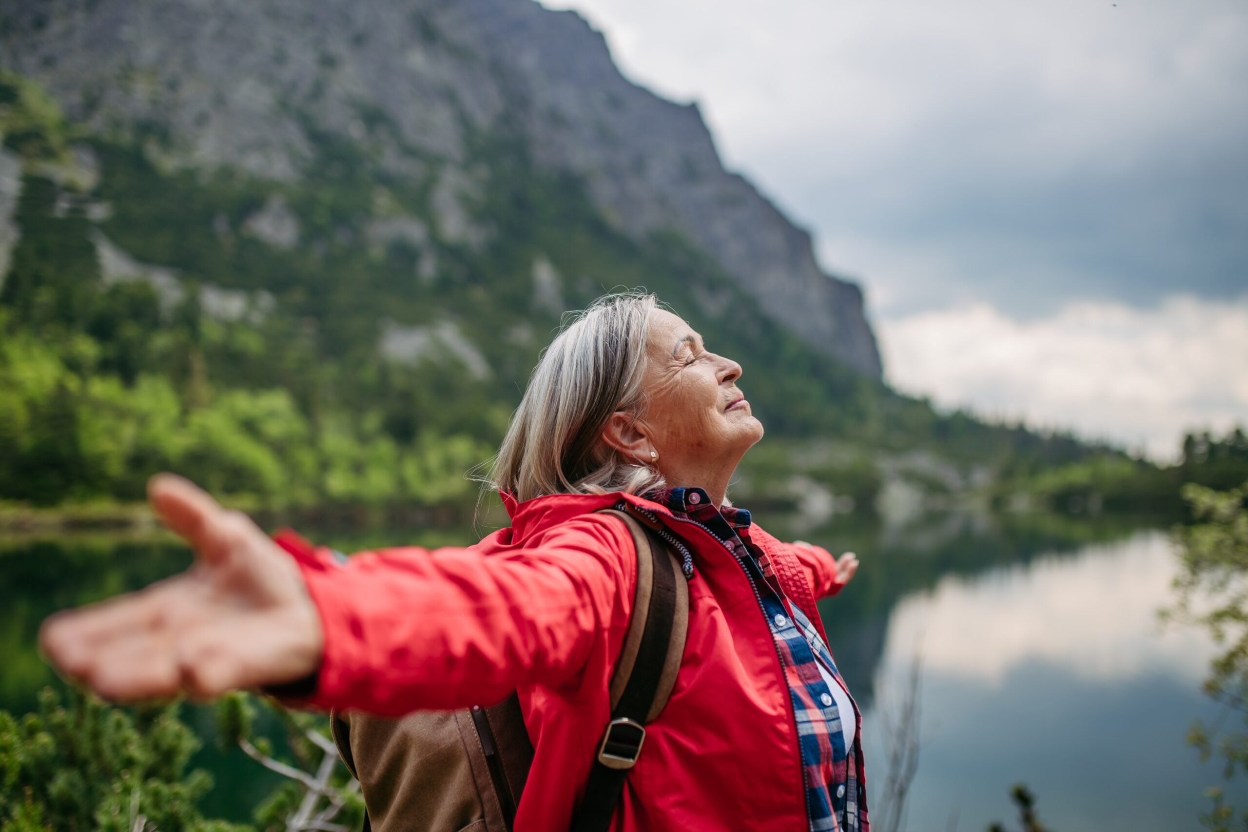 happy older woman over 50 in solo travel