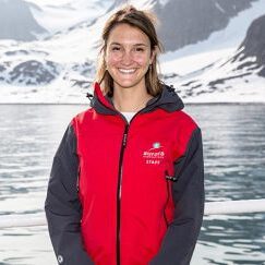 woman smiling in red jacket aurora expeditions