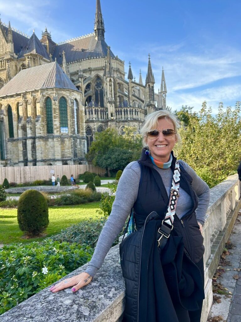 Carolyn woman standing in front of cathedral reims france