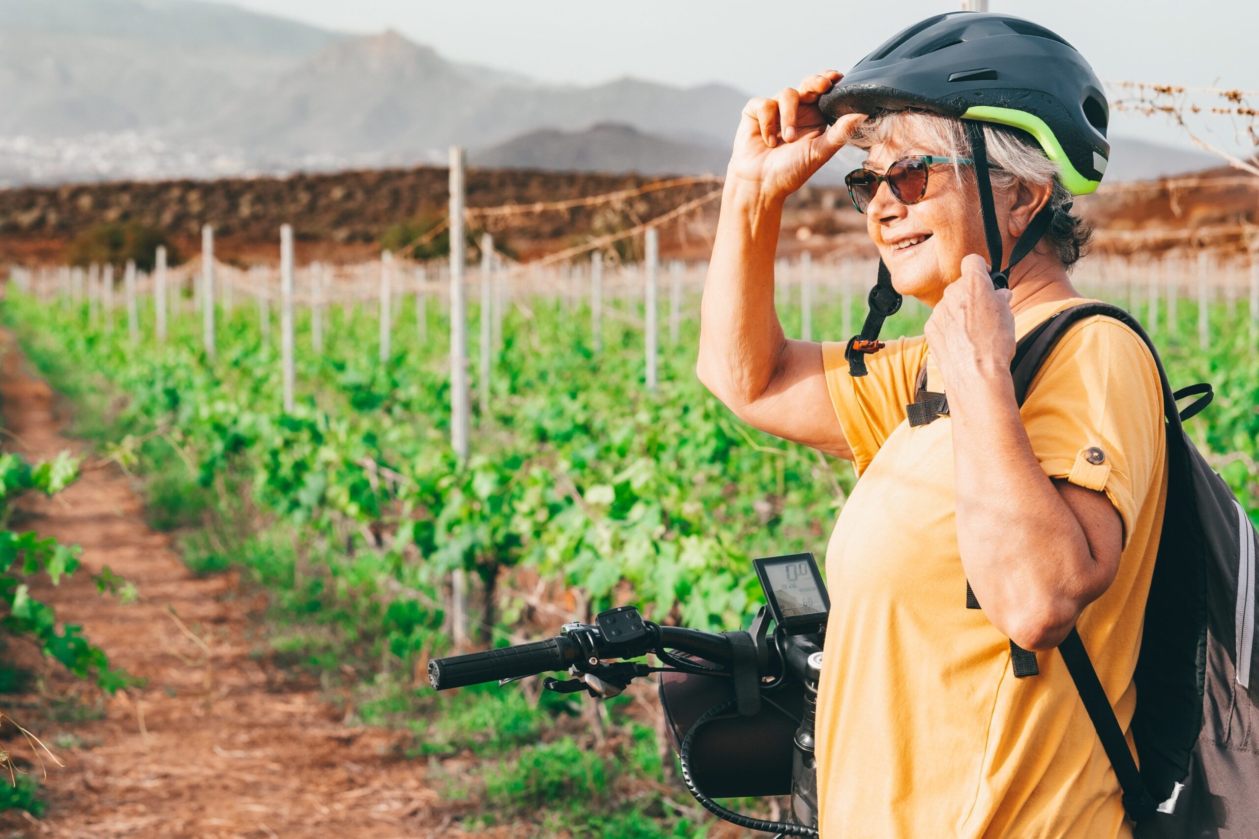 senior woman biking in Bordeaux France in Vineyards