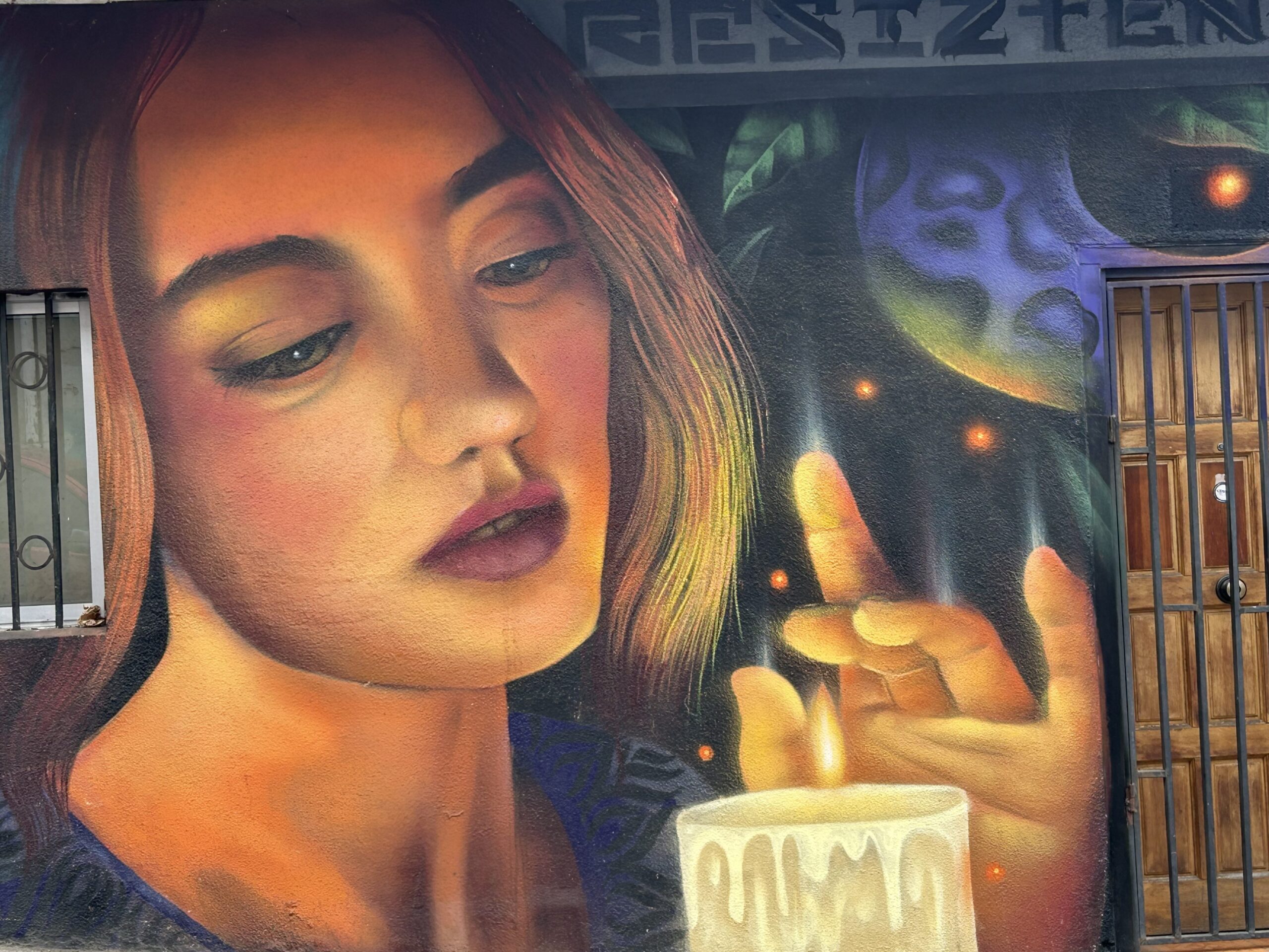 woman holding candle valpariaso street art