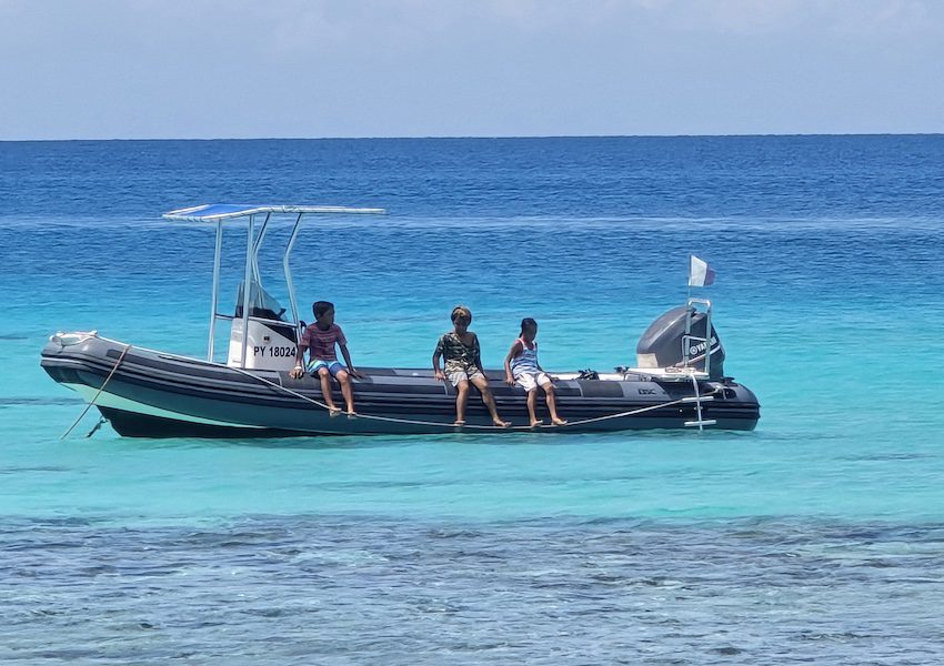 Children on a boat in Rangiroa, French Polynesia