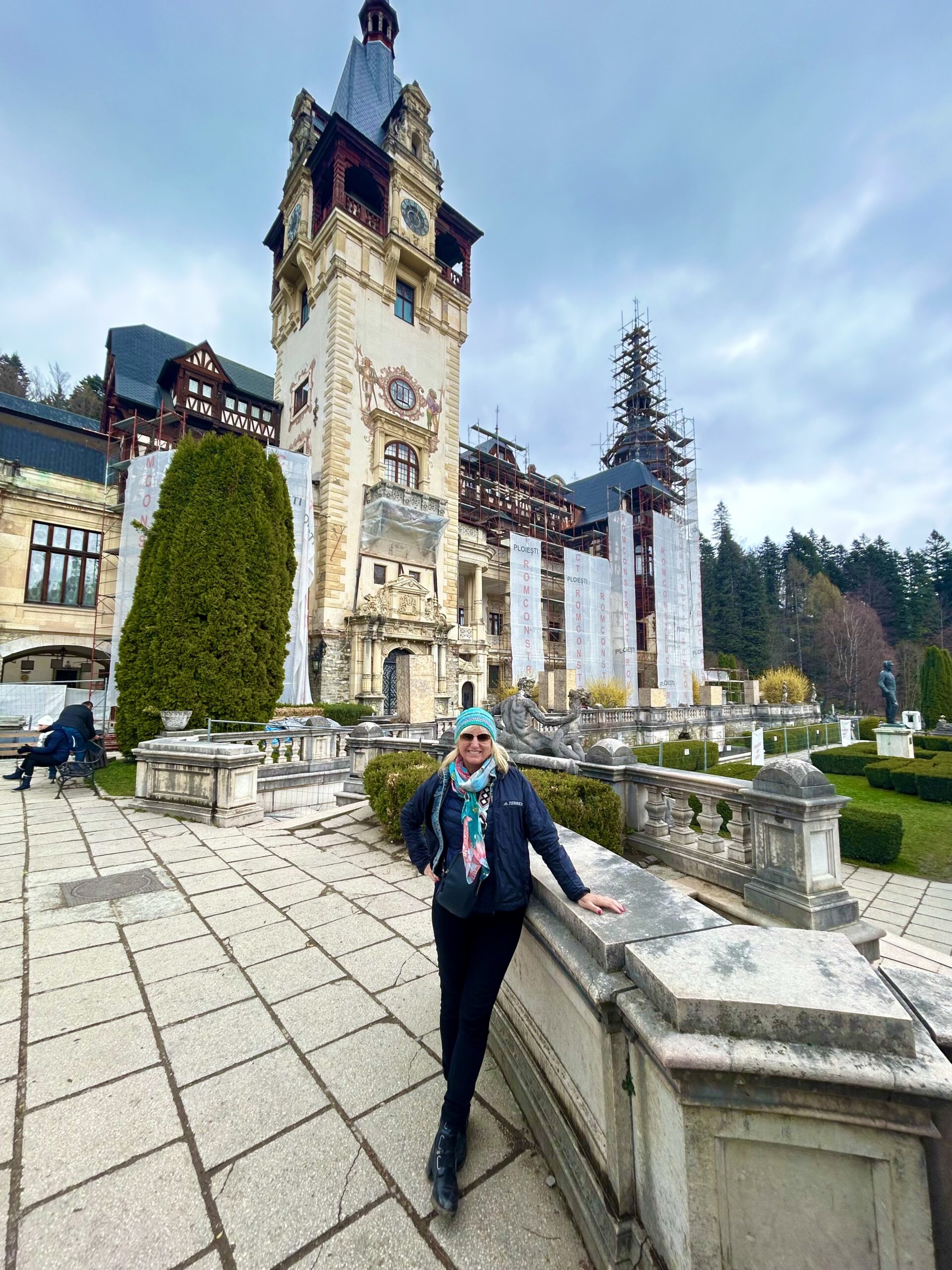 journeywoman's carolyn ray woman standing in front of peles cstle romania road trip
