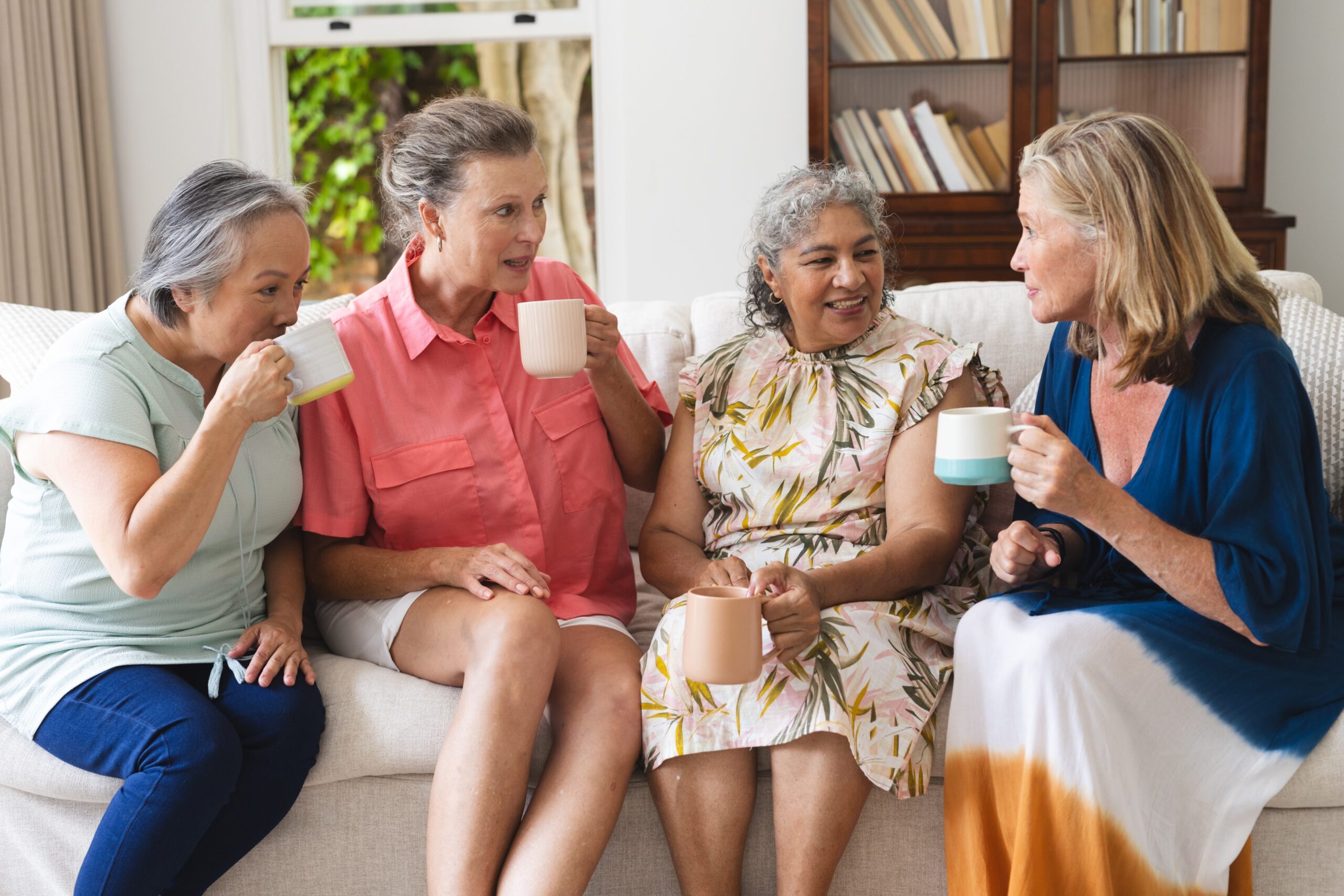 four older women learning new language over coffee