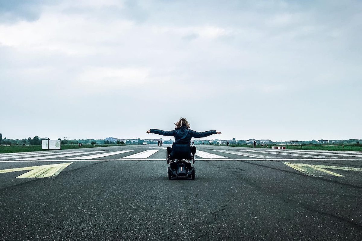 Sylvia Longmuire with her arms open on a runway