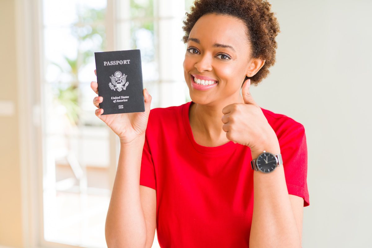 A woman holding her passport after learning how to get a US passport