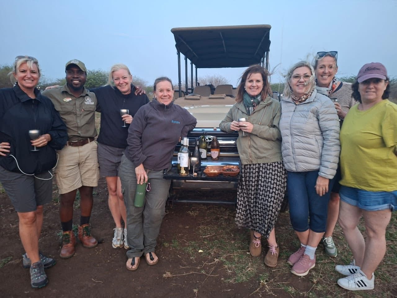 women on safari south africa jeep blue sky