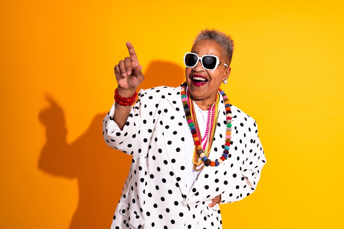 Colorful portrait of funny senior woman wearing stylish clothing