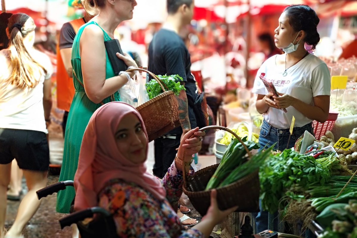 Picking ingredients from local market before the cooking class in Bangkok