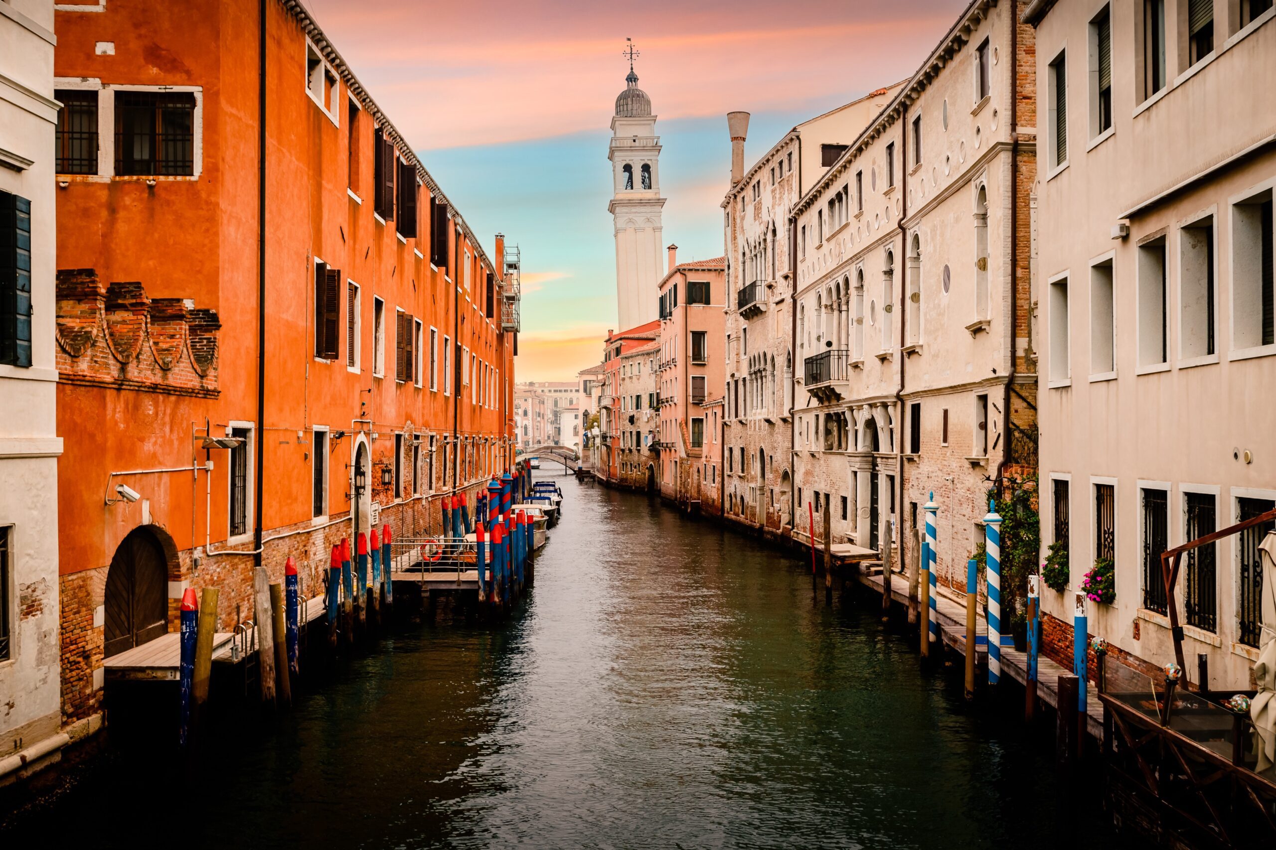 venice canal italy =t sunset with famous crooked bell tower in the background by jancattaneo